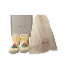 Load image into Gallery viewer, Lemony yellow Sock Shoe with a smiling watermelon cartoon (Sock with a BPA free silicone sole) for first walkers and toddlers, shoe box and a cotton drawstring bag containing mystery baby socks with grip, like yoga socks to assist anti-slip.